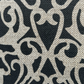 Handprinted fretwork cushion cover in black on natural linen with architectural design