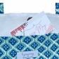 Noosa Escape Chopstick Handle Clutch Bag with vibrant blue and sea green block-printed cotton and white chopstick handles.